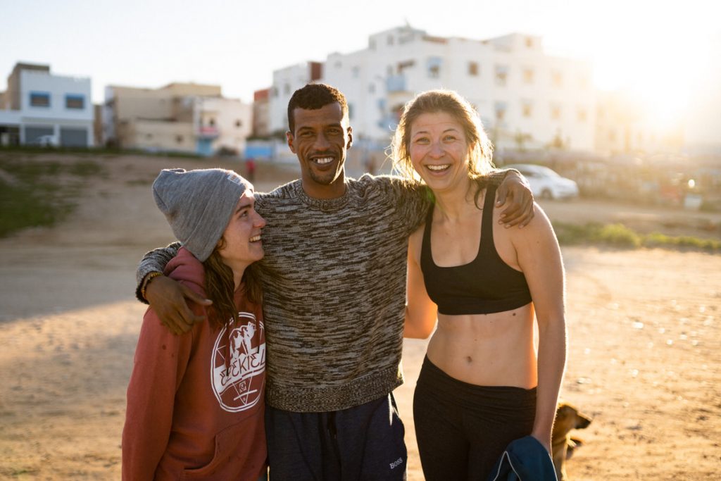 3 people on the beach smiling