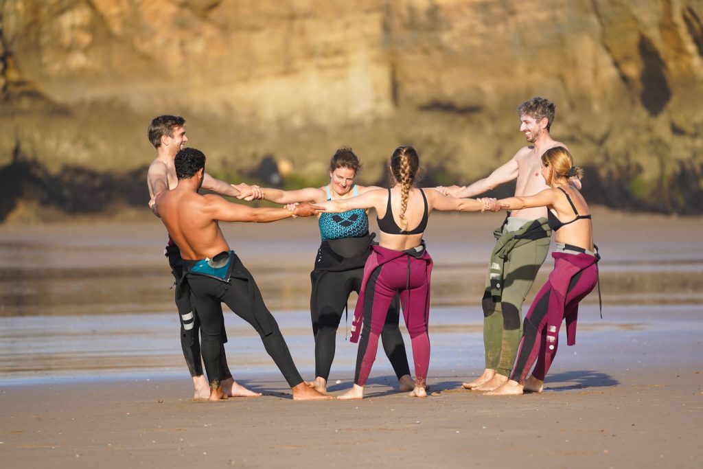 surfers stretching on the beach