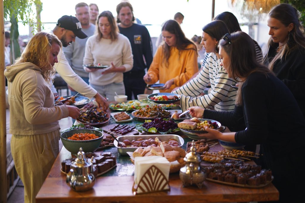 People around a table full of moroccain food