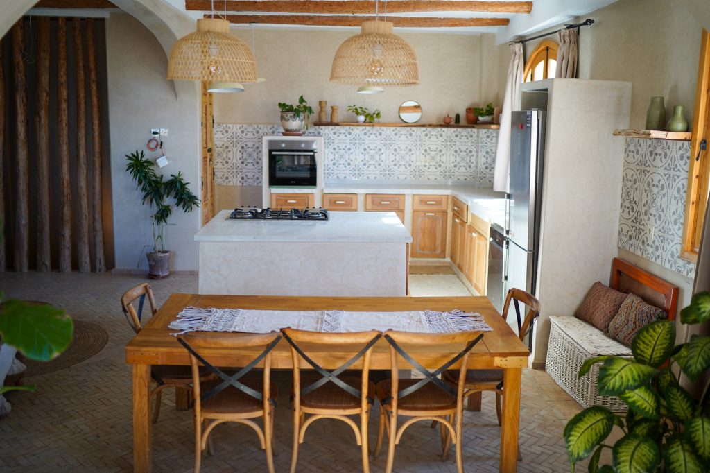 A kitchen in a moroccain Riad with blue tiles and wooden furniture